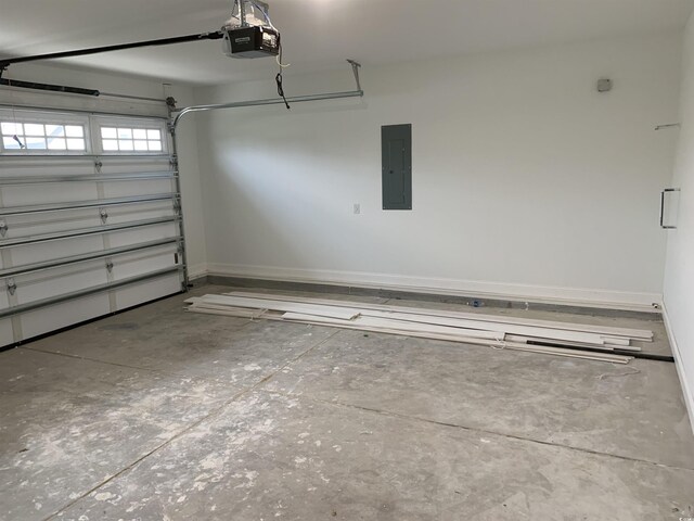 garage with a garage door opener and electric panel