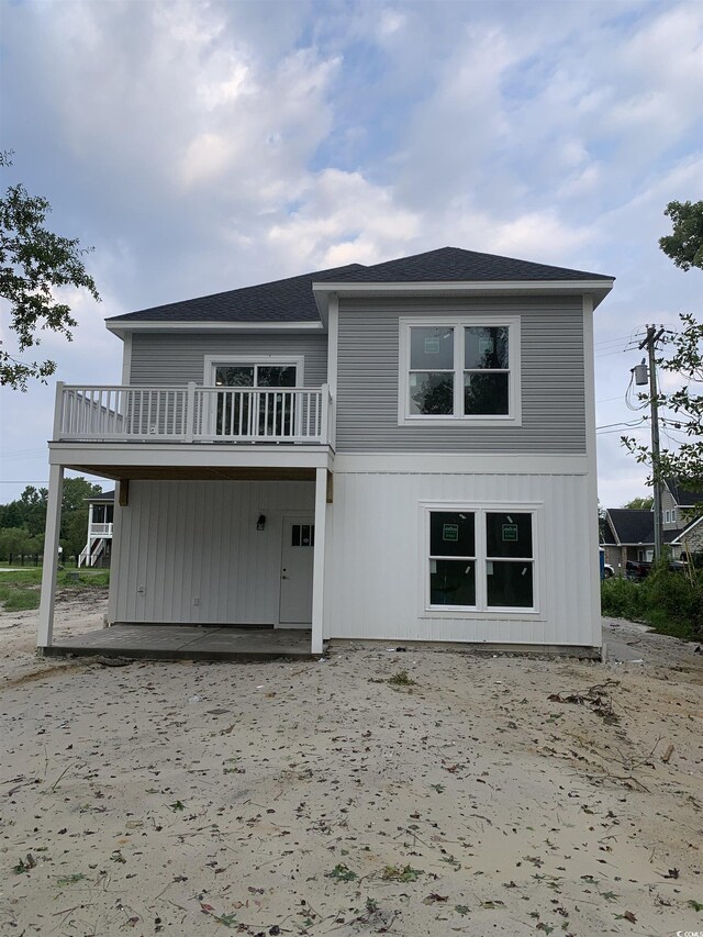 rear view of property with a balcony