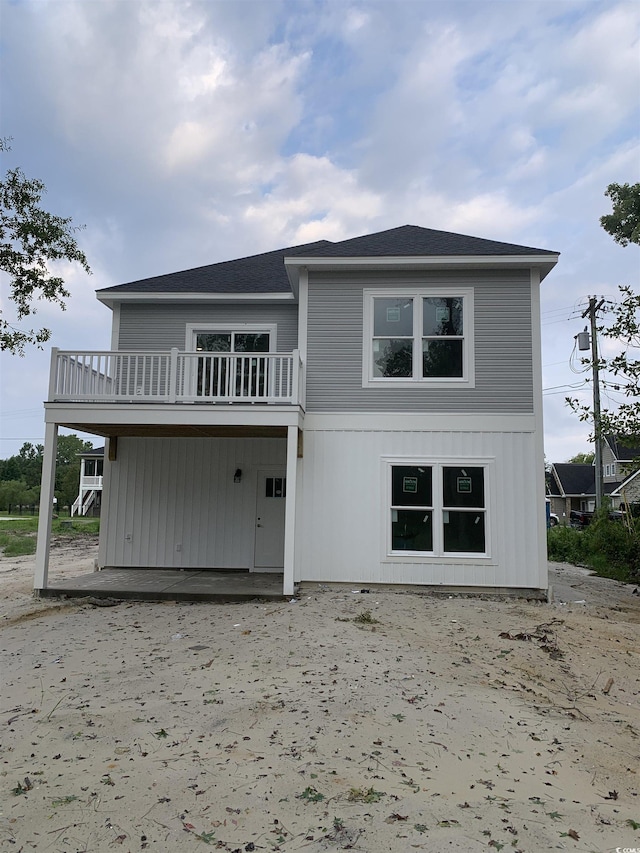 back of house featuring a balcony