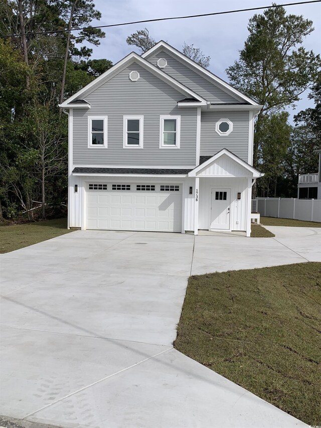 view of front of home featuring a garage and a front lawn