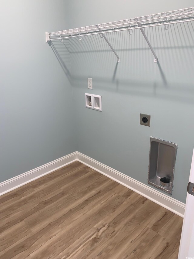 laundry area featuring hookup for a washing machine, hardwood / wood-style flooring, and electric dryer hookup