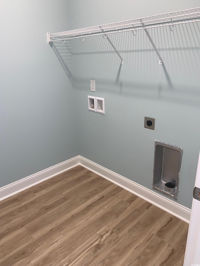 clothes washing area with hardwood / wood-style flooring, hookup for a washing machine, and electric dryer hookup