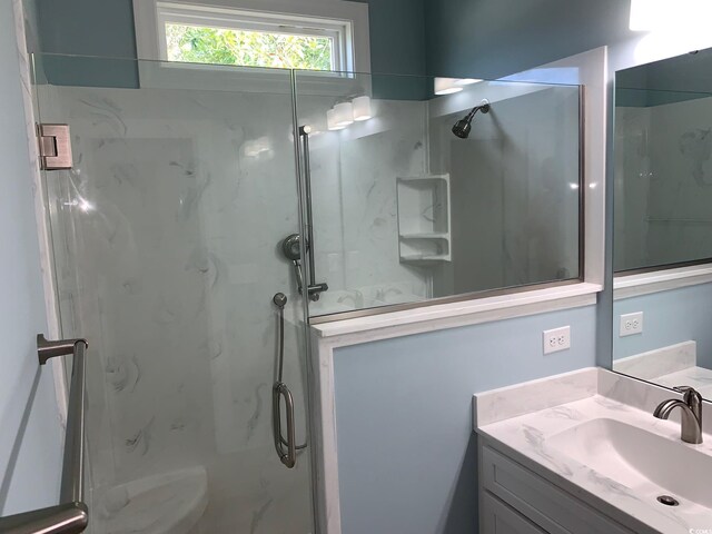 bathroom featuring vanity and tiled shower