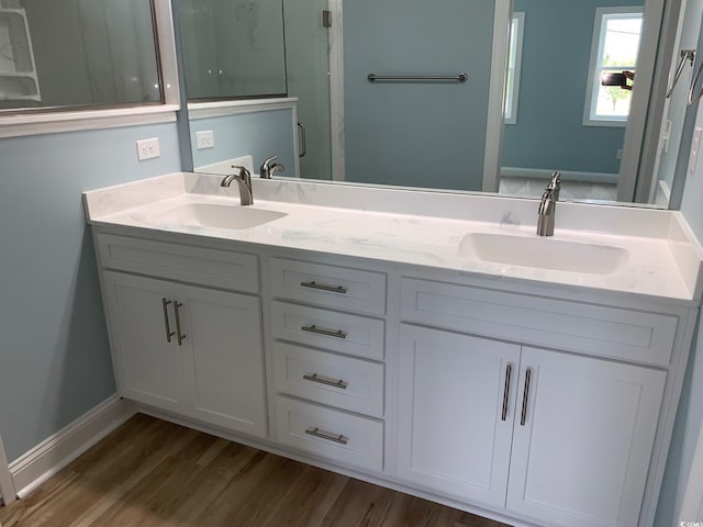 bathroom featuring hardwood / wood-style flooring and vanity