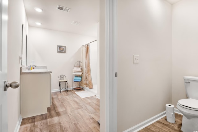 bathroom featuring a shower with curtain, vanity, toilet, and hardwood / wood-style floors