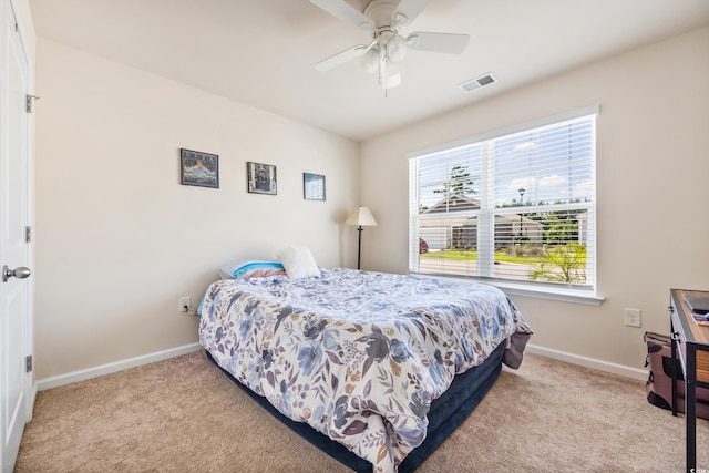 bedroom with light colored carpet and ceiling fan