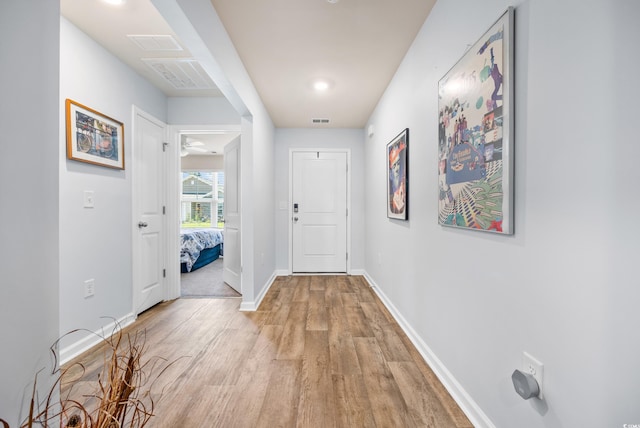 hall with light hardwood / wood-style floors