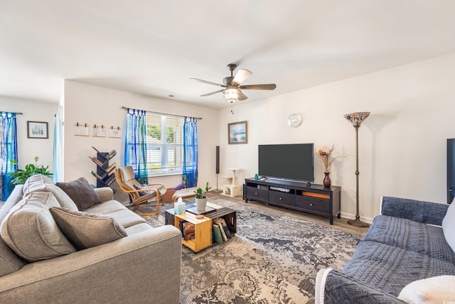 living room with wood-type flooring and ceiling fan