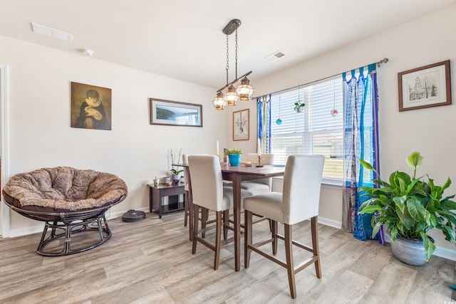 dining space with light hardwood / wood-style flooring