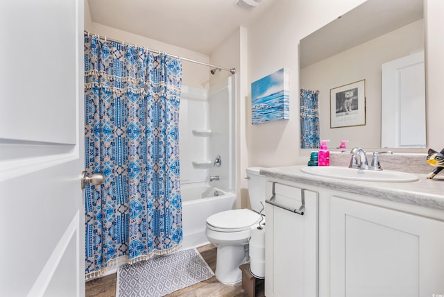 full bathroom featuring vanity, hardwood / wood-style floors, toilet, and shower / bathtub combination with curtain