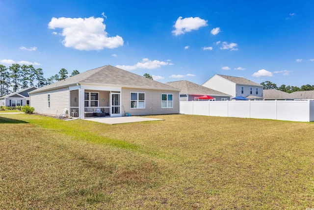 back of house with a patio, a sunroom, and a lawn