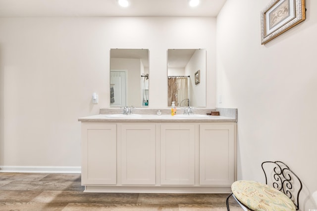 bathroom with vanity and hardwood / wood-style flooring