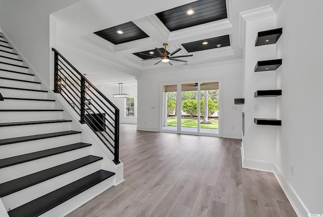 interior space featuring coffered ceiling, ceiling fan, wood-type flooring, ornamental molding, and beam ceiling