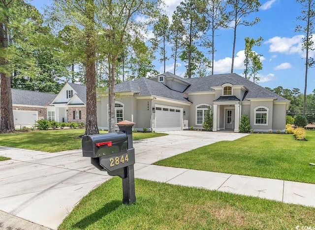 french country inspired facade with a garage and a front yard