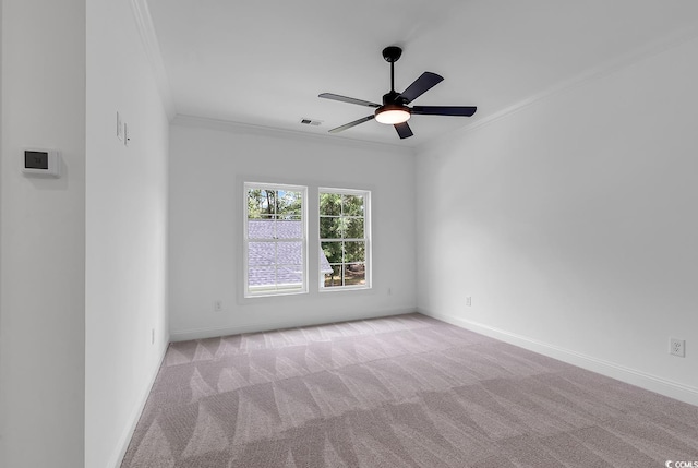 spare room featuring ceiling fan, ornamental molding, and light colored carpet