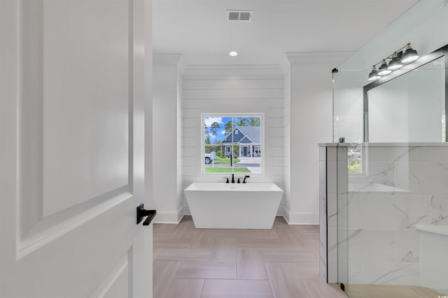 bathroom with parquet floors, ornamental molding, and shower with separate bathtub