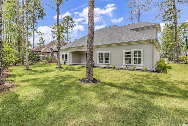 rear view of property featuring a yard