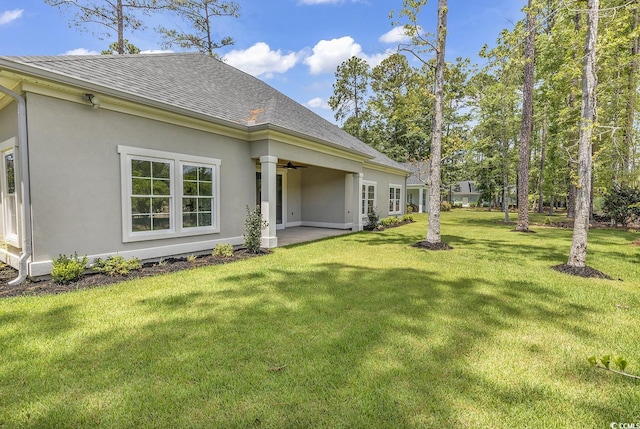 view of yard with a patio area and ceiling fan