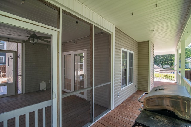 deck with area for grilling and ceiling fan