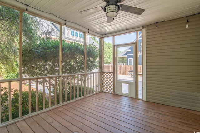 unfurnished sunroom with ceiling fan