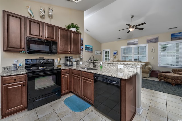 kitchen with black appliances, kitchen peninsula, sink, and light tile patterned floors