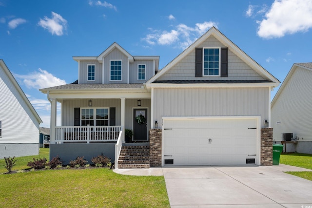 craftsman inspired home featuring central AC unit, covered porch, and a front lawn