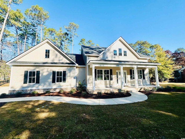 view of front of home featuring covered porch and a front lawn