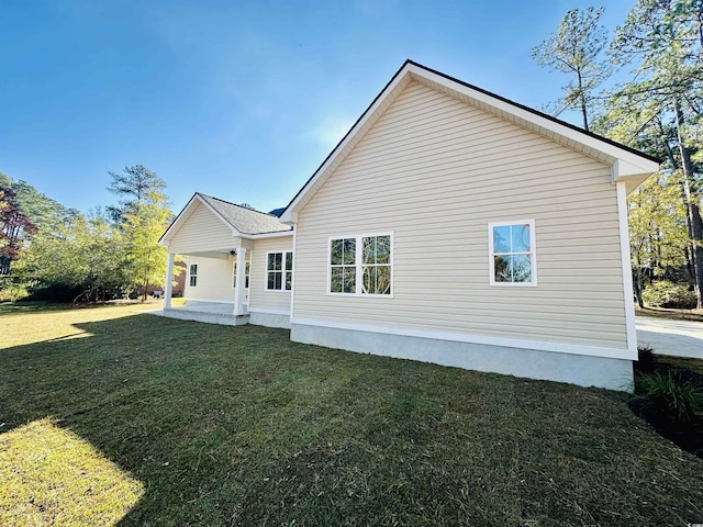 rear view of house with a yard