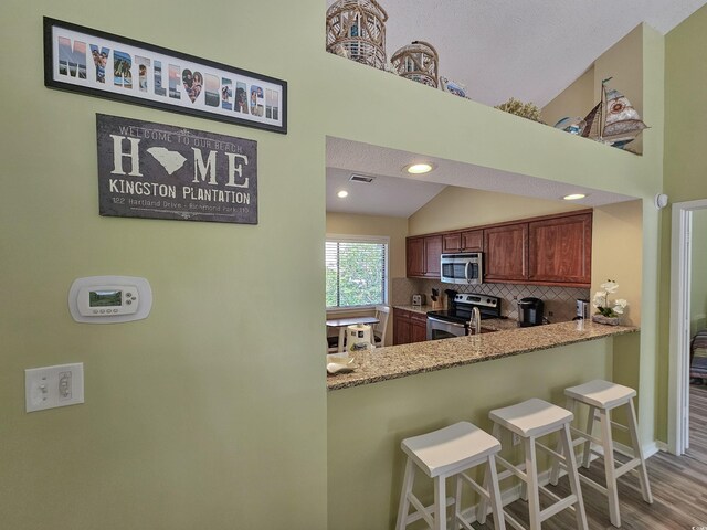 dining area with ceiling fan with notable chandelier, a textured ceiling, high vaulted ceiling, and dark wood-type flooring