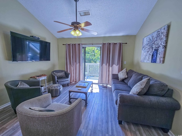 living room with a textured ceiling, lofted ceiling, ceiling fan, and hardwood / wood-style flooring