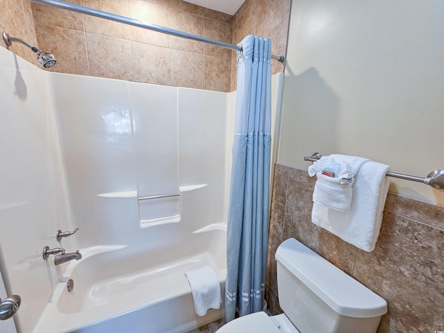 bathroom featuring shower / bath combo with shower curtain and toilet