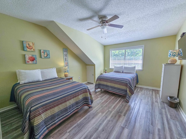 bedroom featuring ceiling fan, a textured ceiling, and light hardwood / wood-style floors