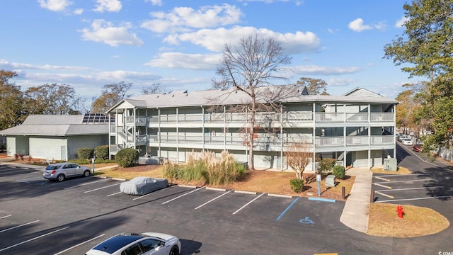 view of property featuring uncovered parking