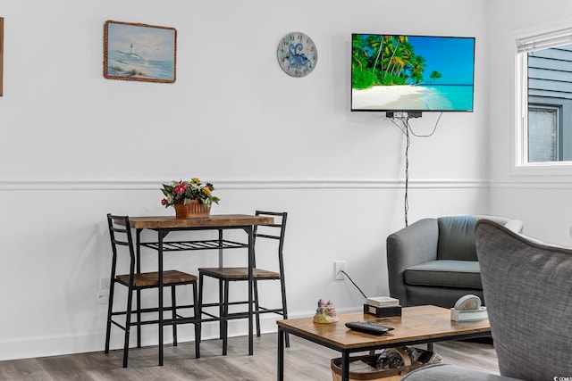 living area featuring baseboards and wood finished floors