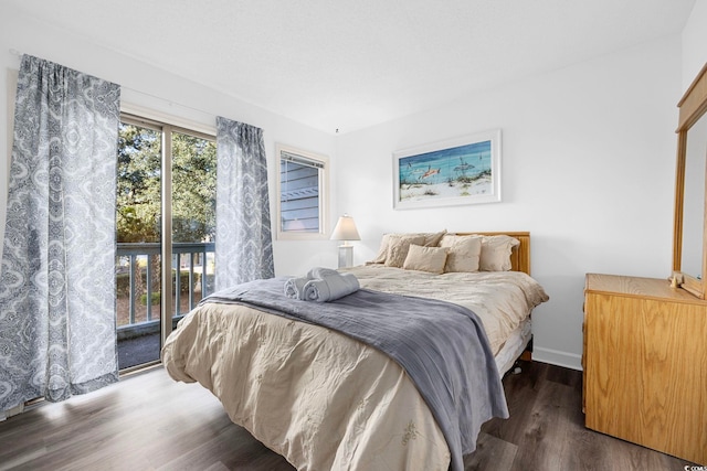 bedroom featuring access to outside, baseboards, and wood finished floors