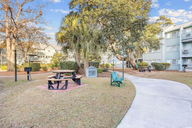 view of property's community with a residential view and a yard