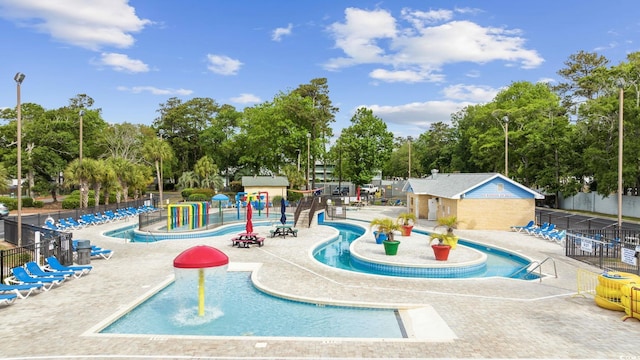 view of community with a patio area, fence, and a pool