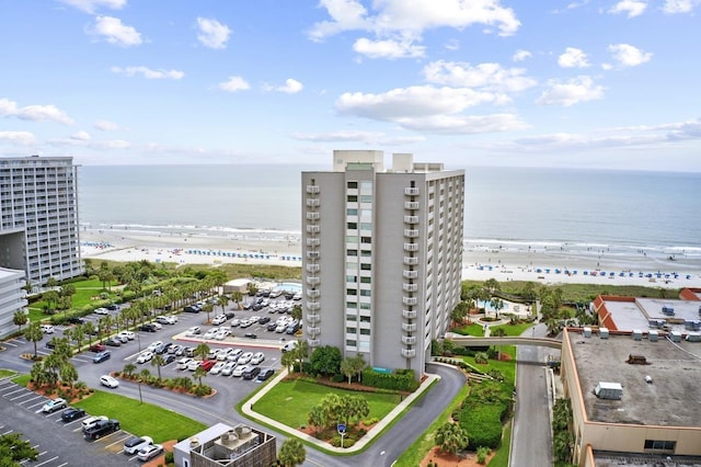 bird's eye view with a water view and a beach view