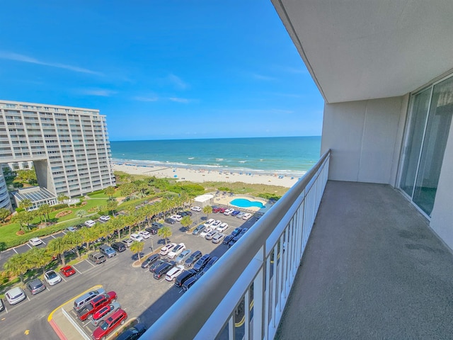 balcony with a view of the beach and a water view