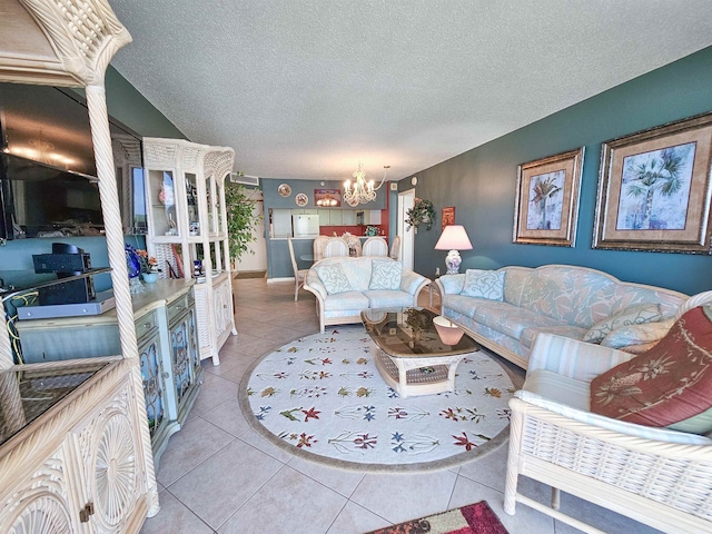 living room with a notable chandelier, tile flooring, and a textured ceiling