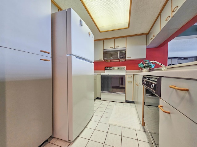 kitchen featuring white appliances and light tile floors