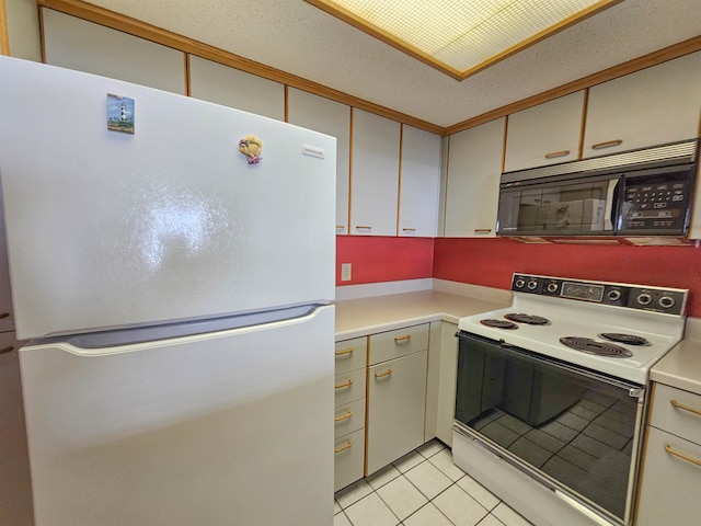 kitchen with a textured ceiling, white appliances, and light tile flooring