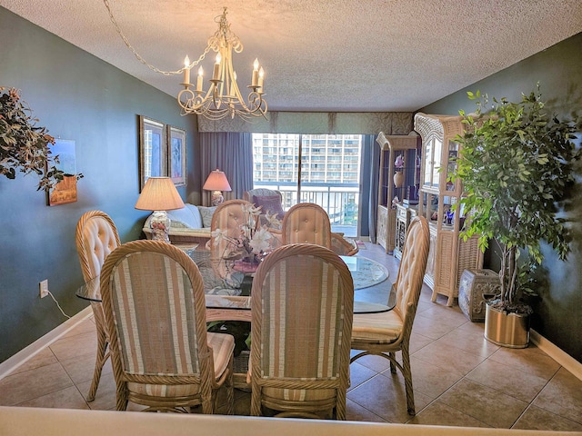 tiled dining space featuring a notable chandelier and a textured ceiling