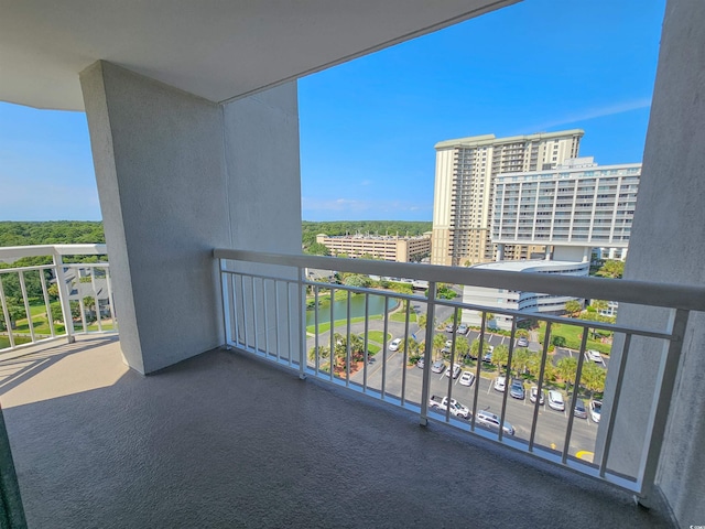 balcony with a view of city and a water view