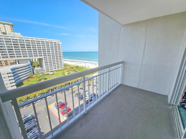 balcony with a view of the beach and a water view