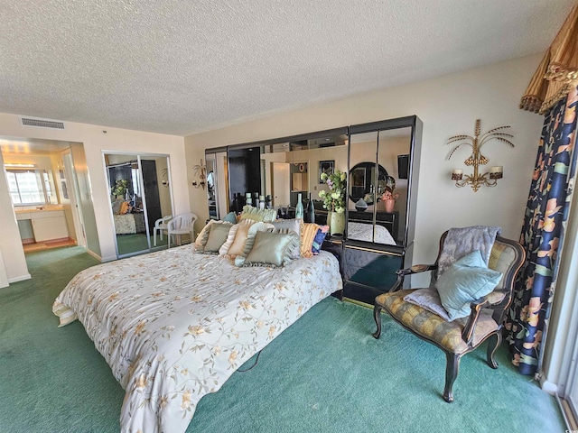 bedroom with a textured ceiling and carpet floors