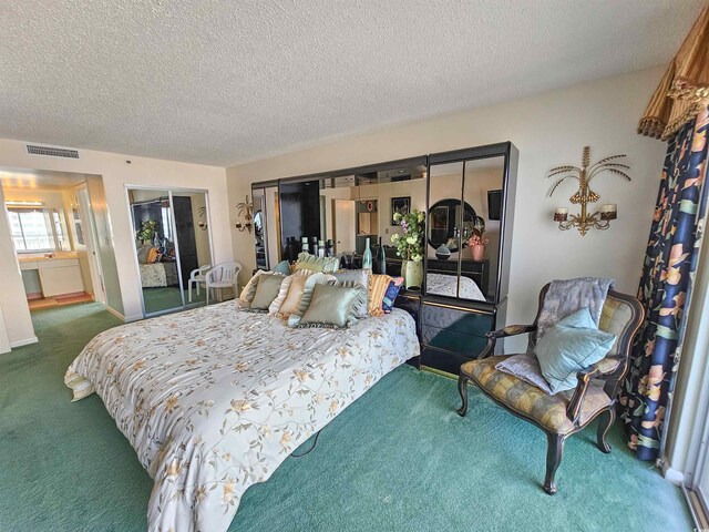 bedroom featuring visible vents, carpet floors, and a textured ceiling