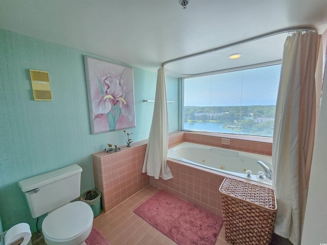 bathroom with tile patterned flooring, a jetted tub, wallpapered walls, and toilet