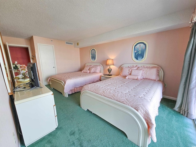 bedroom featuring a textured ceiling and carpet flooring