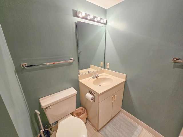 bathroom featuring tile floors, large vanity, and toilet